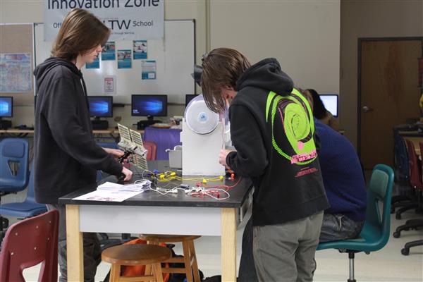  students hunched over project 