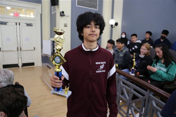  boy holding trophy 