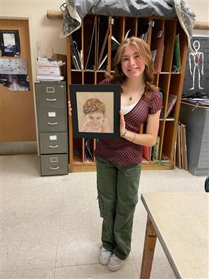 girl shows off her winning art 