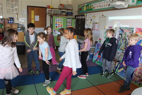  students dancing in classroom 