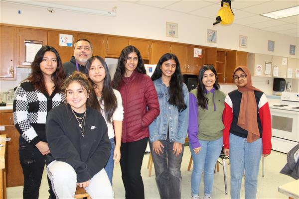  students in club smiling for camera 