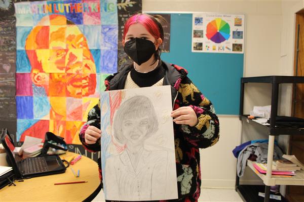  girl holding artwork of Oprah 