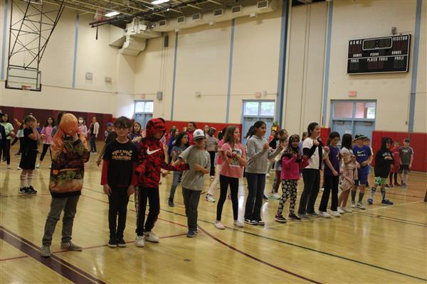  students dancing in gym 