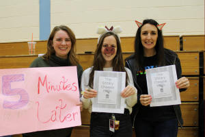  Teachers holding signs and wearing costumes