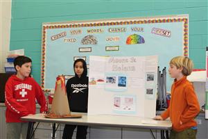 students presenting a volcano together 