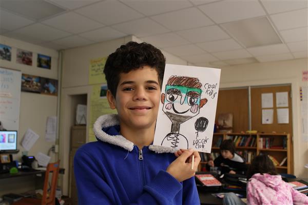 Student holding his  continuous line portrait mask
