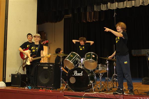 students on stage pointing  