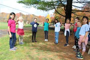 girls making hearts with hands in a chain 