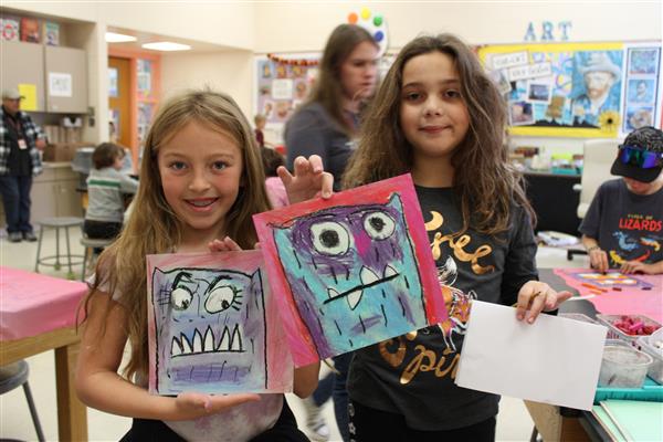  Students holding their monster artwork