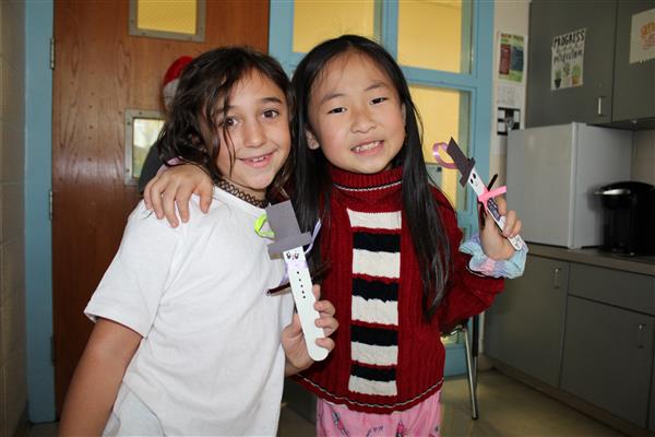  Students holding popsicle stick snowmen