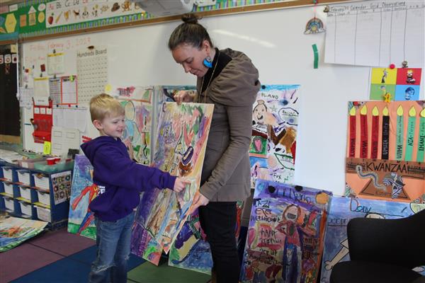  student pointing to art 