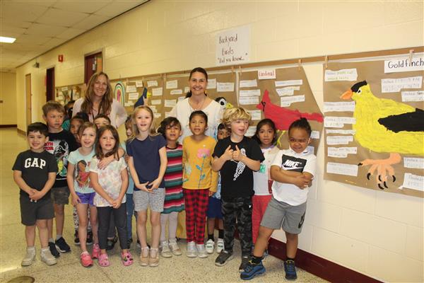  students posing in hallway 