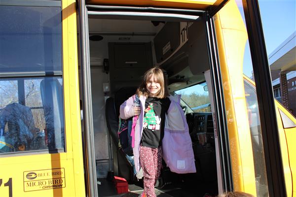  Students smiling as they arrive for school